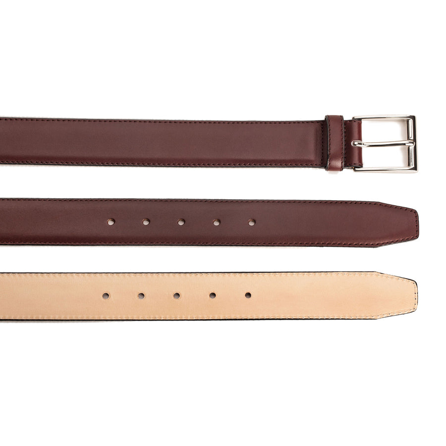 Meermin burgundy calf belts shown alongside natural leather strap, comparing buckle end and hole punches, nickel-plated buckle visible on top strap
