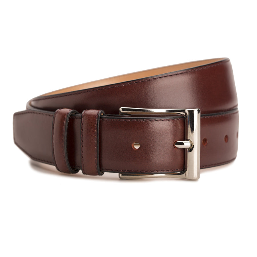 Meermin burgundy boxcalf belt, coiled to show buckle detail with nickel-plated solid brass frame and keeper loops