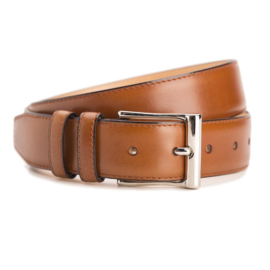 Meermin beechnut boxcalf belt, coiled to show buckle and loop detail, nickel-plated solid brass buckle in focus