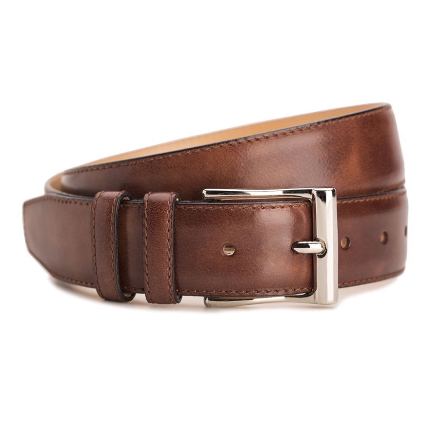 Meermin cognac Museum Calf belt, coiled to show buckle and double keeper, nickel-plated solid brass buckle in focus