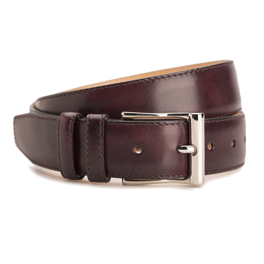 Meermin plum Museum Calf belt, coiled to show buckle detail with nickel-plated solid brass buckle and double keeper loops