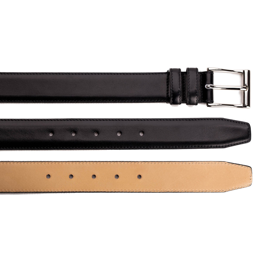 Meermin black boxcalf belt, layered view showing buckle end, punched holes, and vegetable-tanned leather lining strip