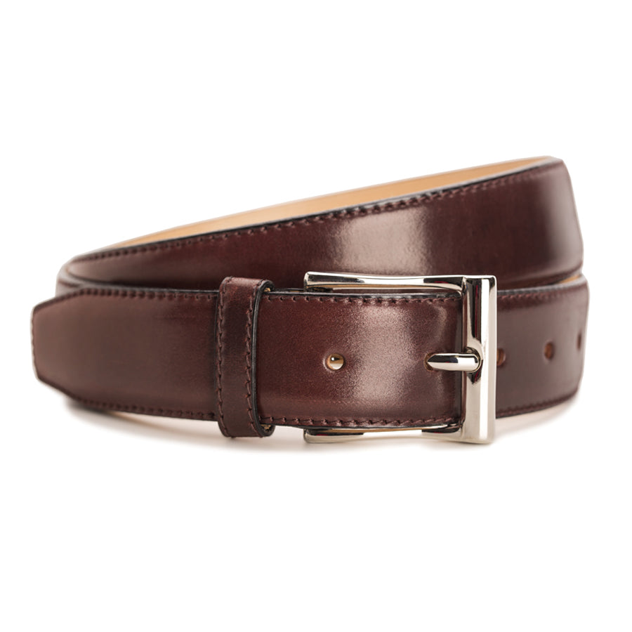 Meermin burgundy shell cordovan belt, coiled to show buckle detail with nickel-plated solid brass hardware