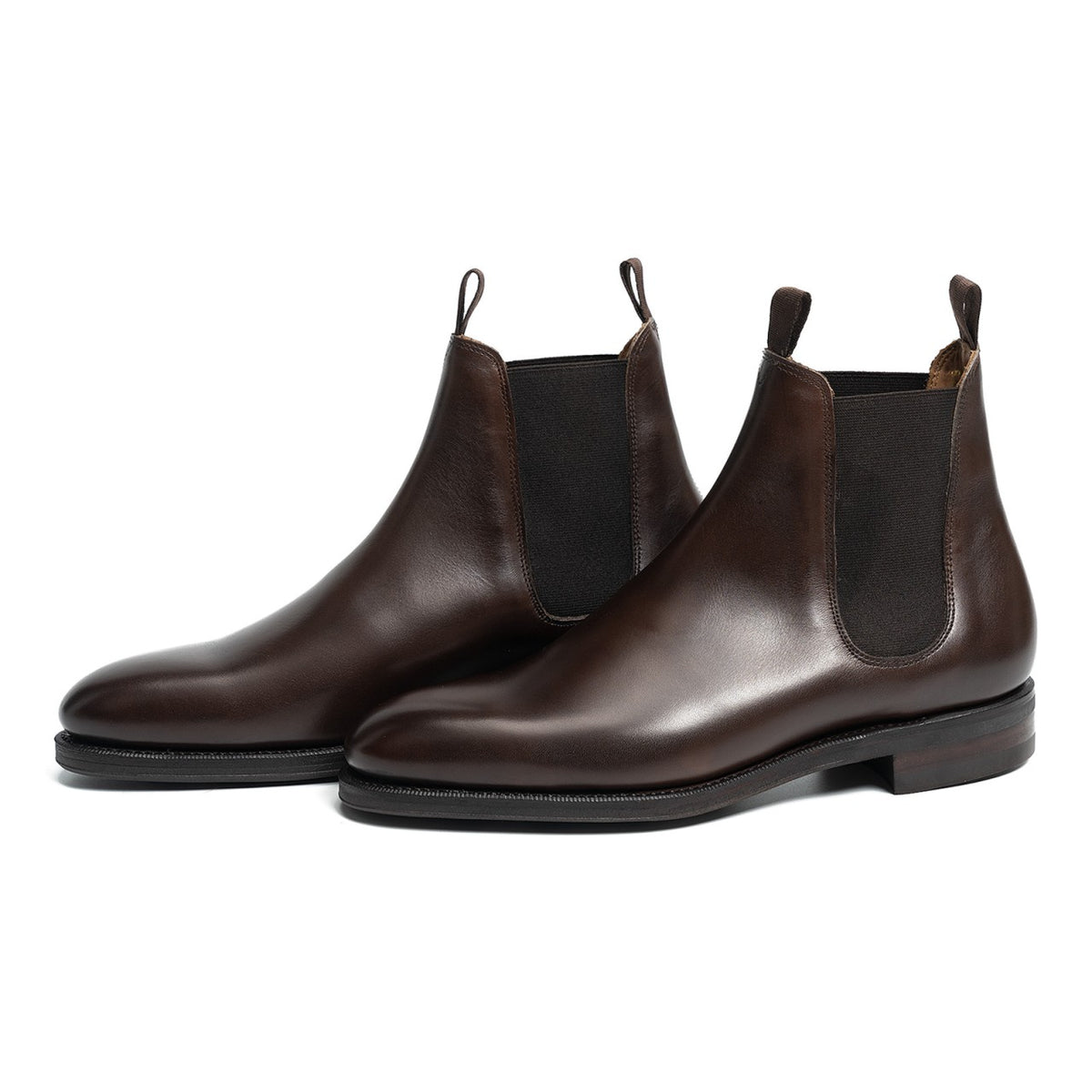 Meermin dark brown calfskin wholecut Chelsea boots, pair shown at three-quarter angle showing elastic gussets and pull tabs