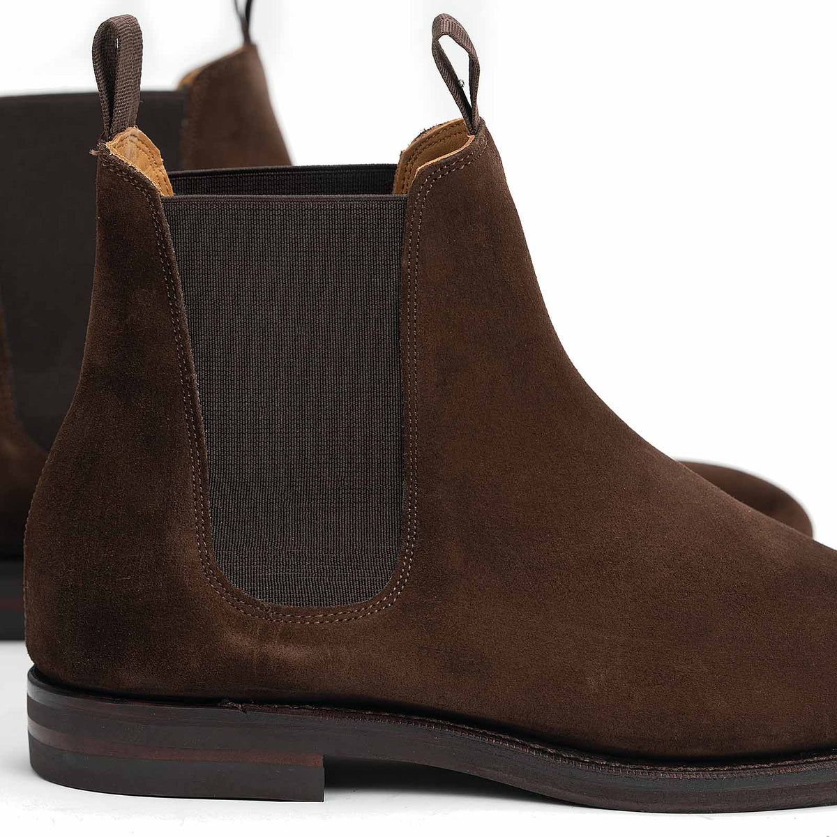 Meermin brown suede Chelsea boot, close-up rear view showing elastic gusset, pull tab, and Goodyear welted rubber sole
