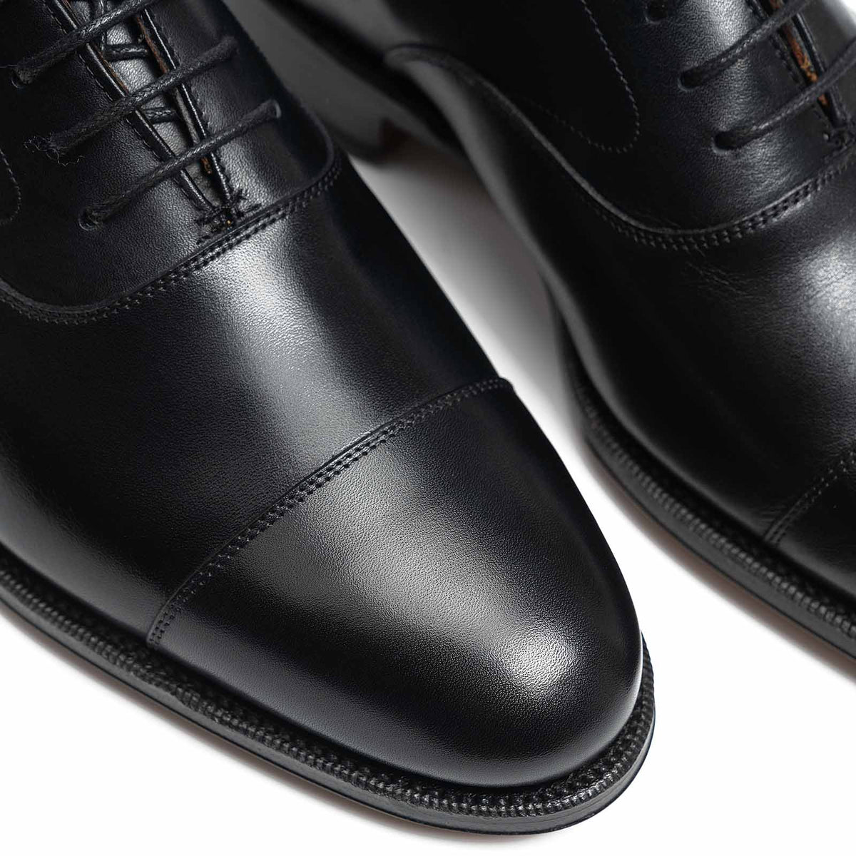 Meermin black boxcalf cap-toe Oxfords, close-up on toe caps showing stitching detail and closed channel leather soles