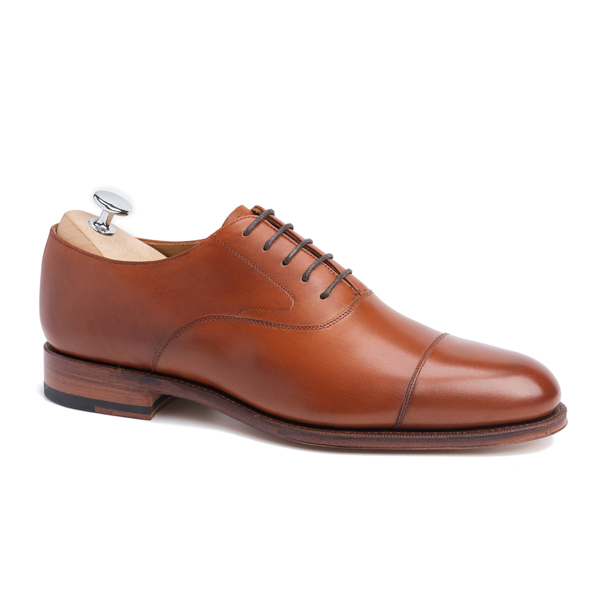 Meermin copper boxcalf cap-toe Oxford, side profile on shoe tree, showing closed channel leather sole and stacked heel