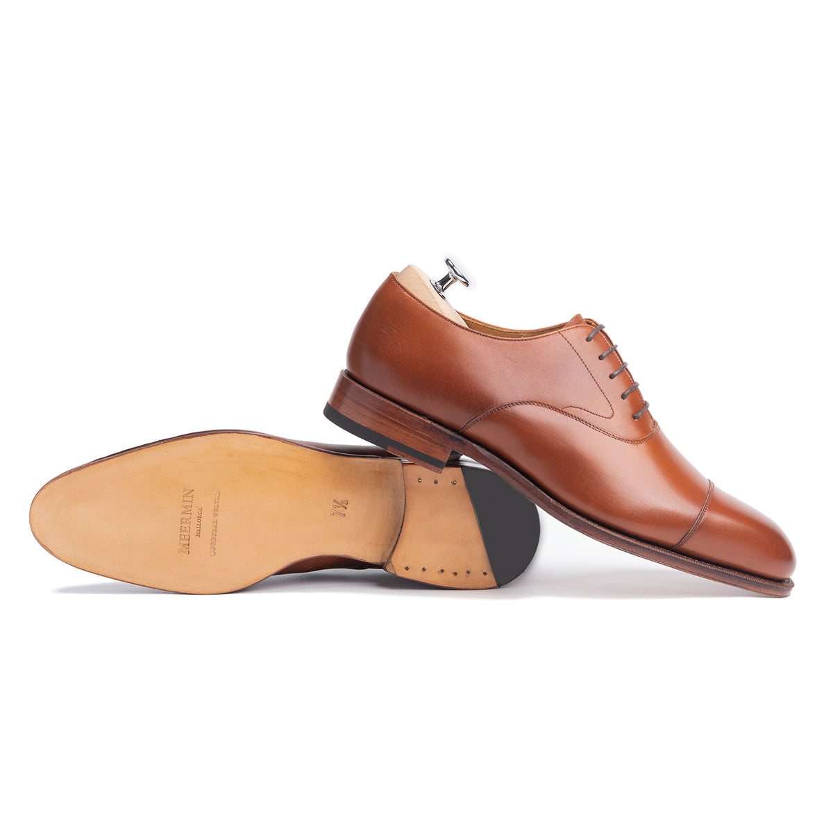 Meermin copper boxcalf cap-toe Oxford pair, one shoe upright on tree, one shown sole-up revealing closed channel leather sole