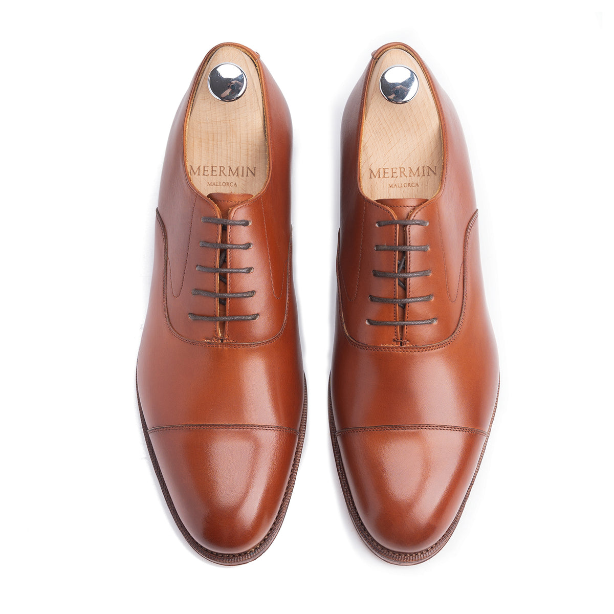 Meermin copper boxcalf cap-toe Oxfords, top-down view on shoe trees, showing lace detail and closed channel leather soles