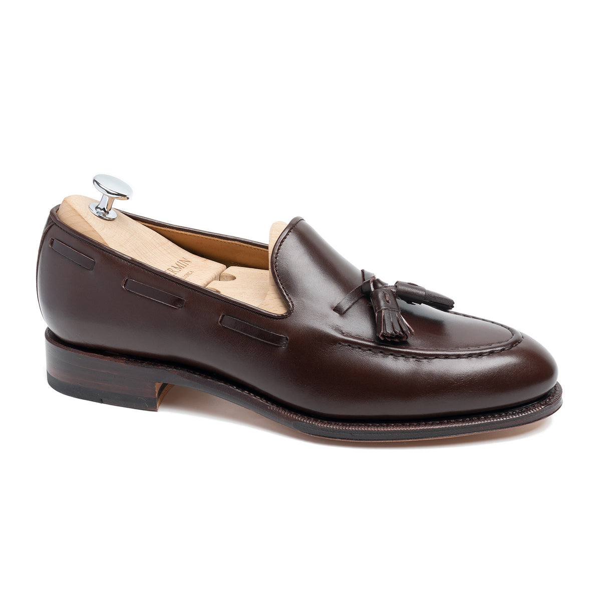 Meermin dark brown boxcalf tassel loafer, side profile on a shoe tree, showing hand-sewn apron and Goodyear welted sole