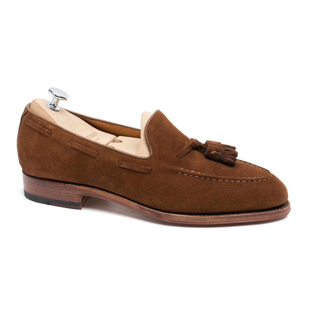 Meermin snuff suede tassel loafer, side profile on a shoe tree, showing hand-sewn apron and closed-channel leather sole