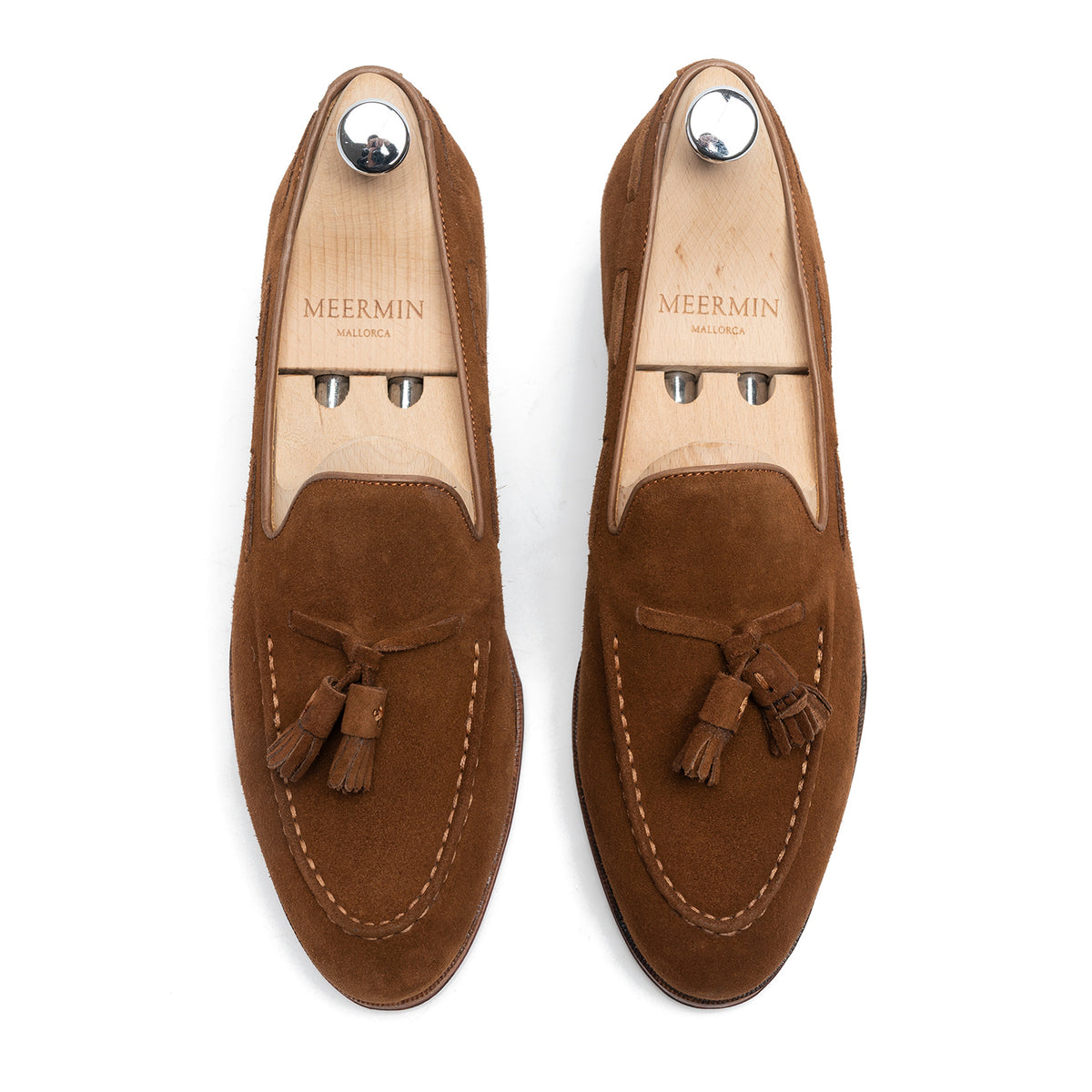 Meermin snuff suede tassel loafers, top-down view on shoe trees, showing hand-sewn apron and tassel detail