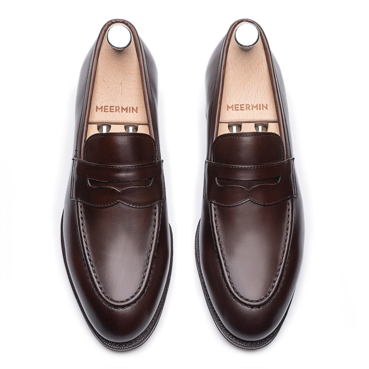Meermin espresso antique calf penny loafers, top-down view of both shoes with wooden shoe trees inserted