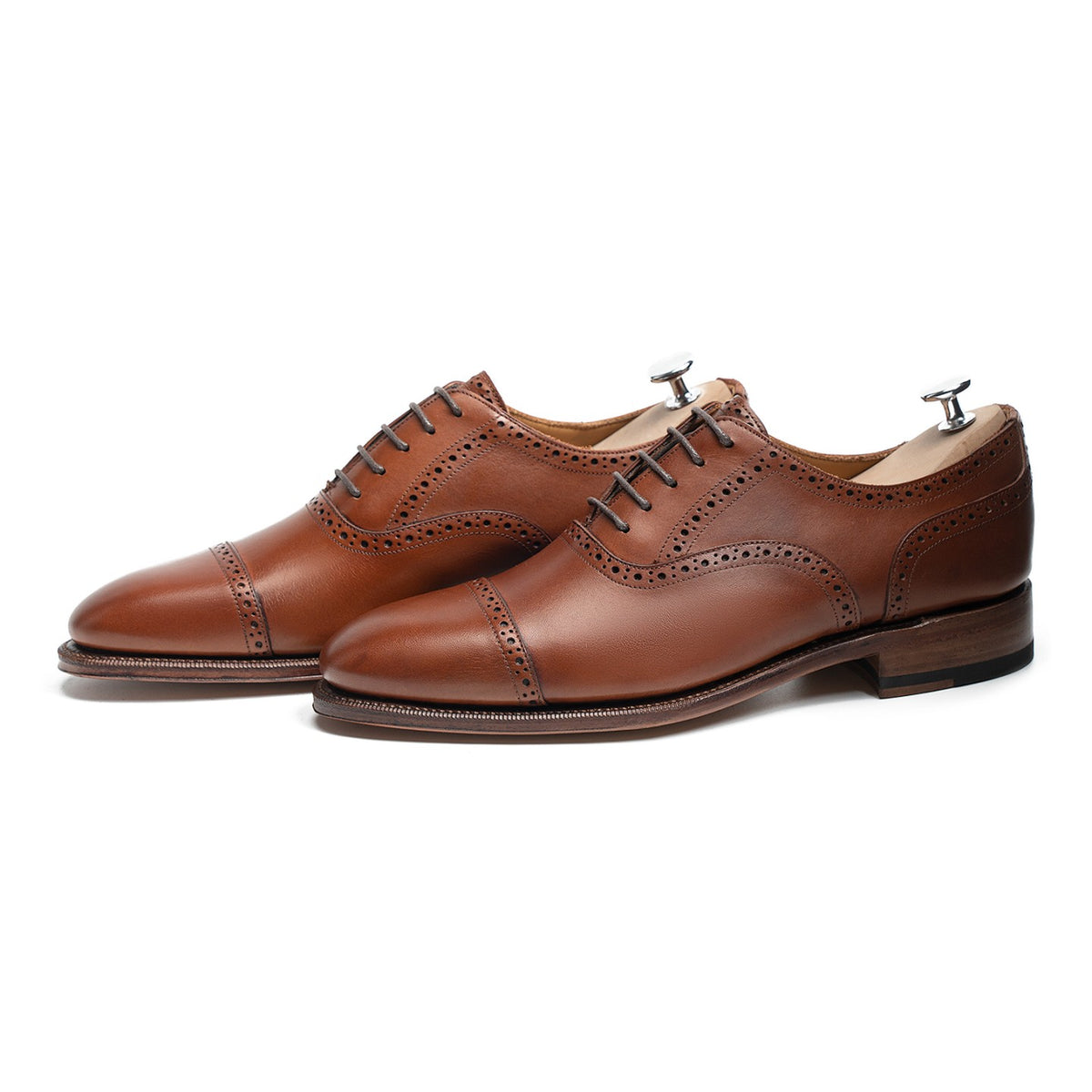 Meermin tan antique calf brogued cap-toe Oxfords, three-quarter side view on shoe trees, showing broguing detail and closed channel sole
