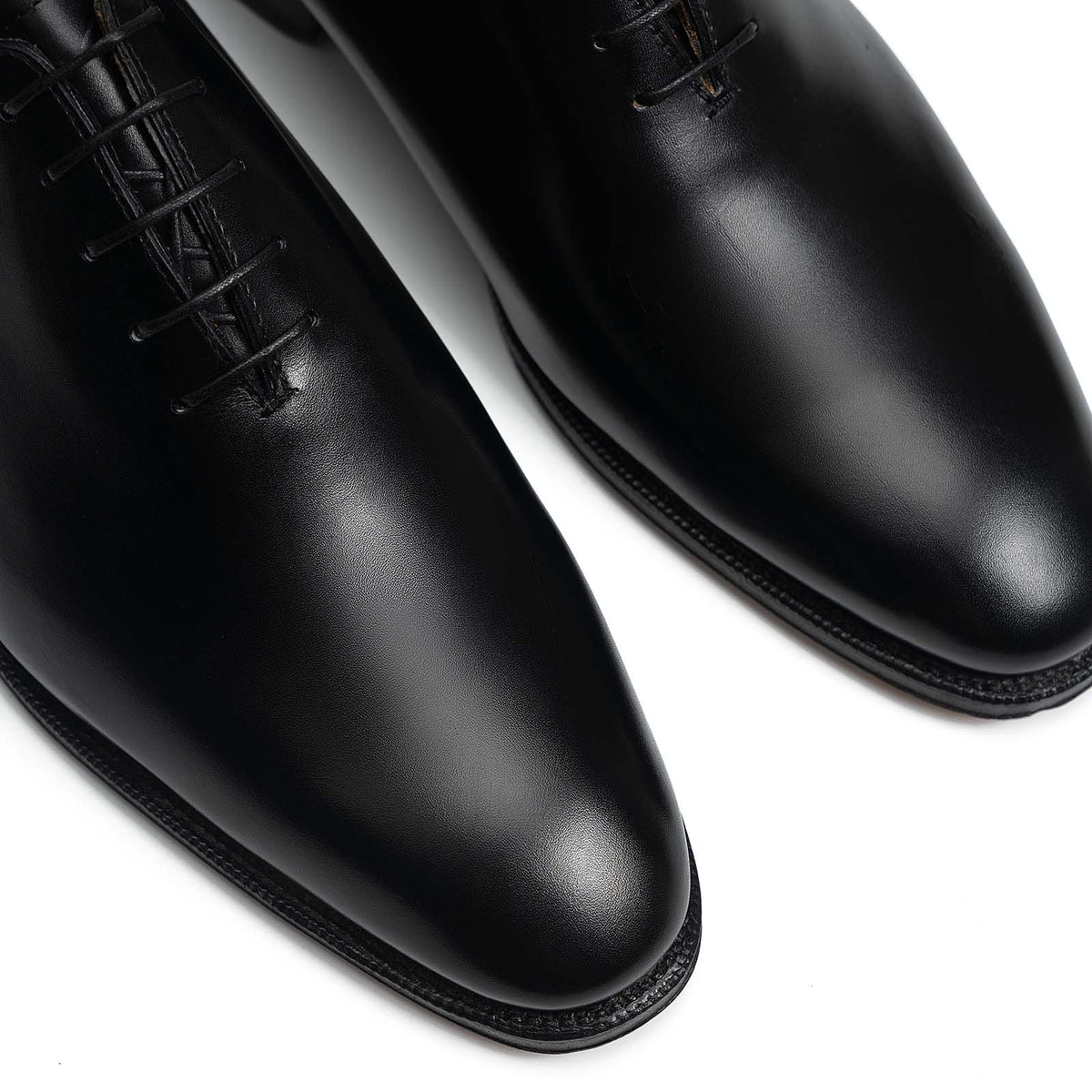 Meermin black boxcalf wholecut Oxfords, close-up of toe caps and lace eyelets showing smooth leather sheen