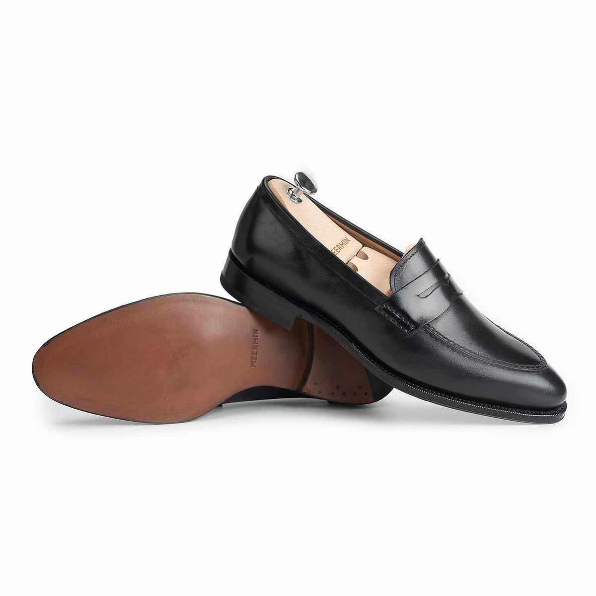 Meermin black boxcalf penny loafers, side view with sole showing chestnut leather and closed-channel construction