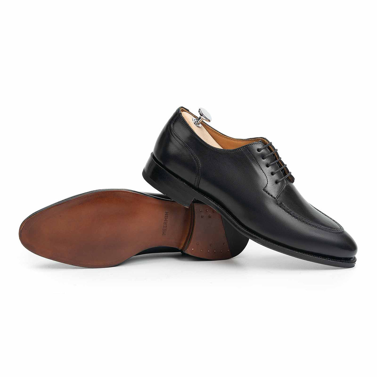 Meermin black boxcalf Norwegian derby, paired shot with one shoe upside down showing chestnut closed-channel leather sole