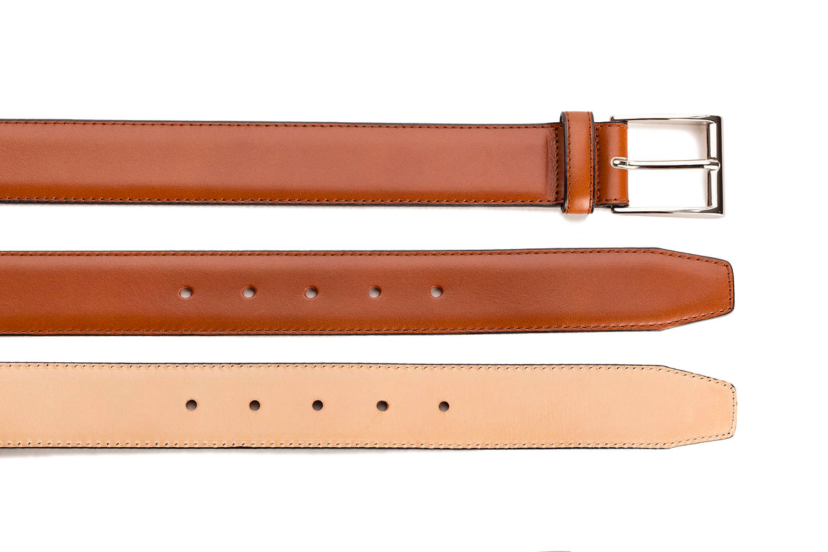 Meermin copper antique calf belt, buckle end with nickel-plated brass buckle, shown above matching strap and unlined natural leather backing