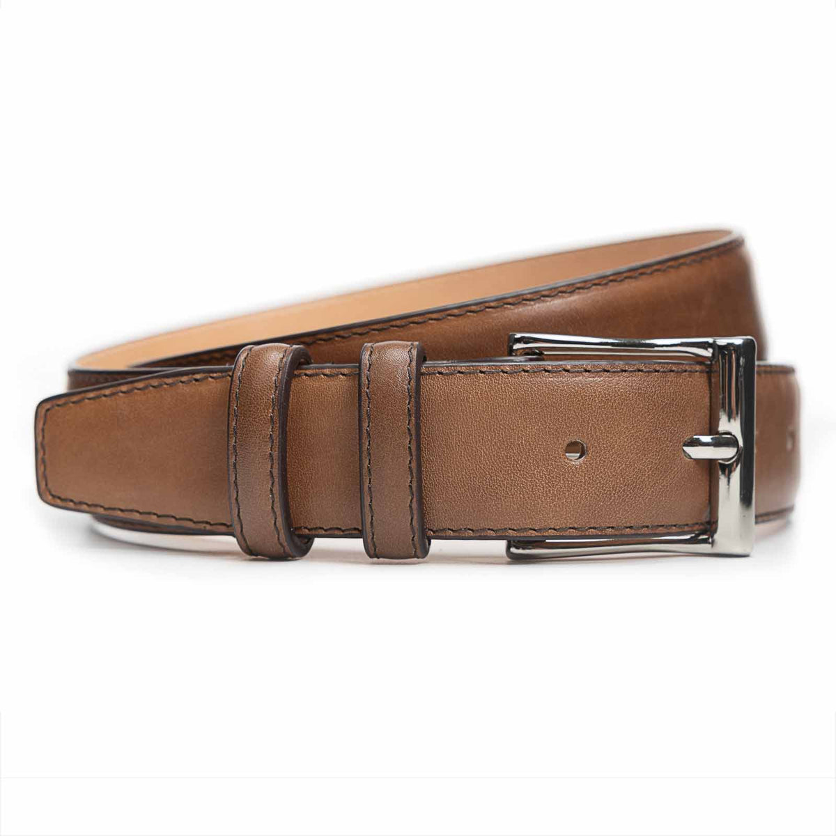 Meermin cognac Misty calfskin belt, coiled to show buckle detail with nickel-plated brass hardware and double keeper loops