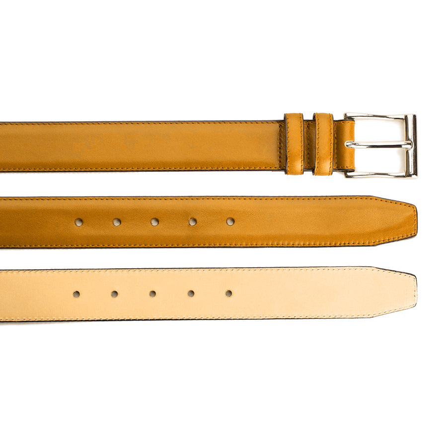 Meermin tan leather belt shown in three views: buckle end with nickel-plated brass buckle, hole-punched strap, and reverse side