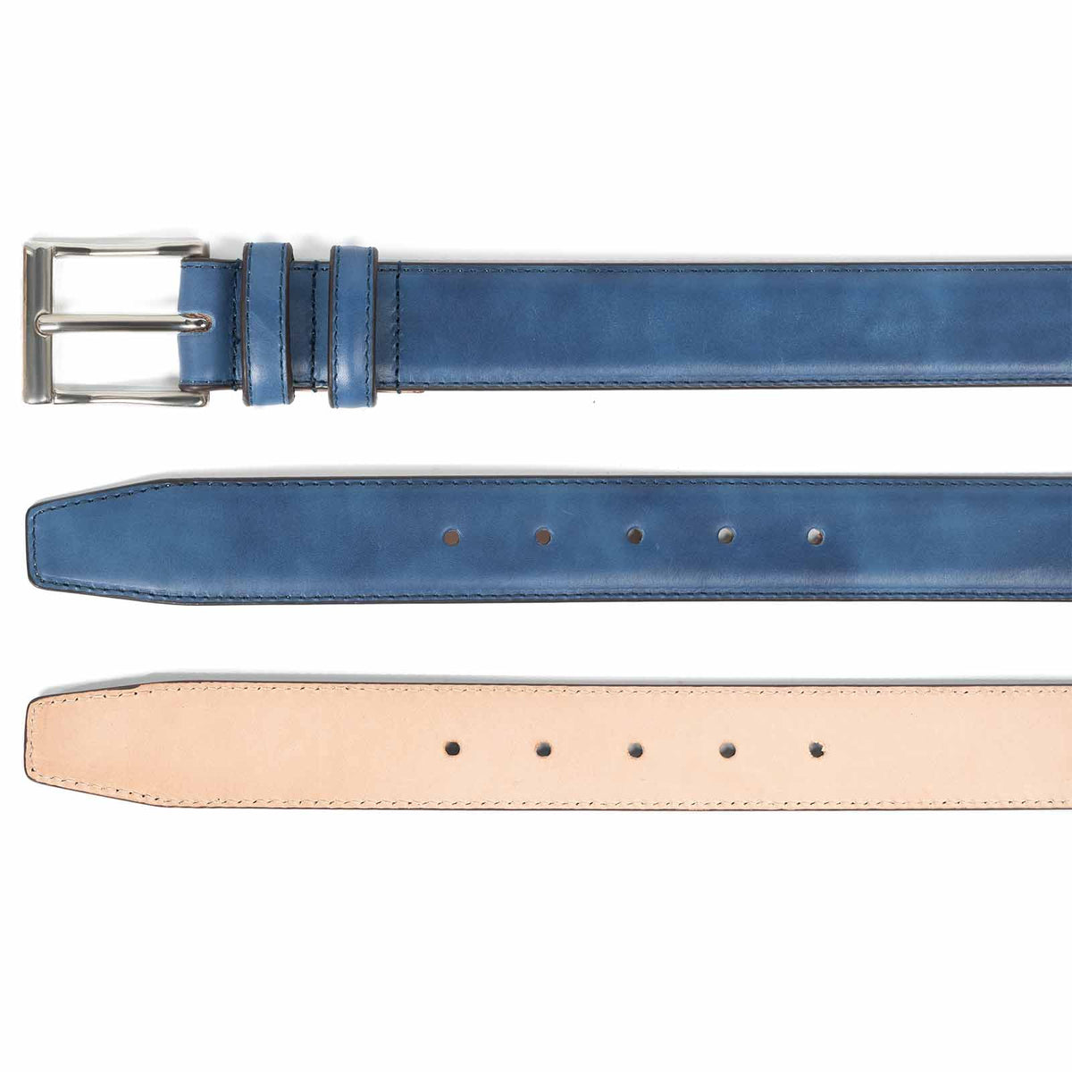 Meermin navy museum calf belt shown buckle end, underside with hole punches, and raw leather back, fully made of leather with no fillers