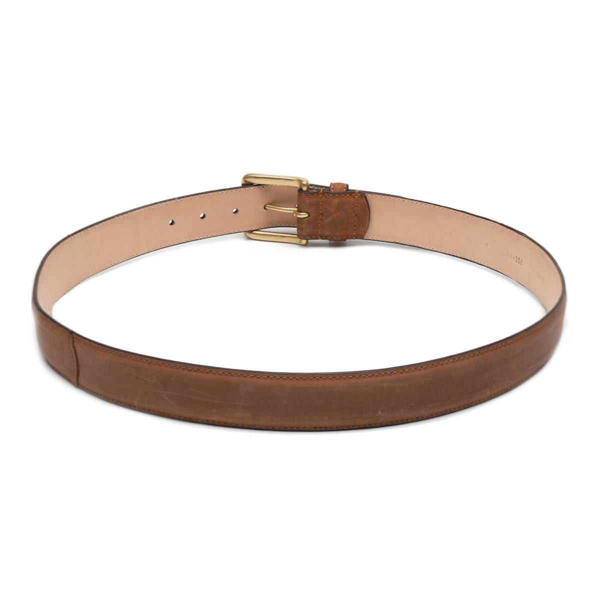 Meermin tobacco shell cordovan belt coiled flat, showing solid brass buckle and vegetable-tanned calfskin lining