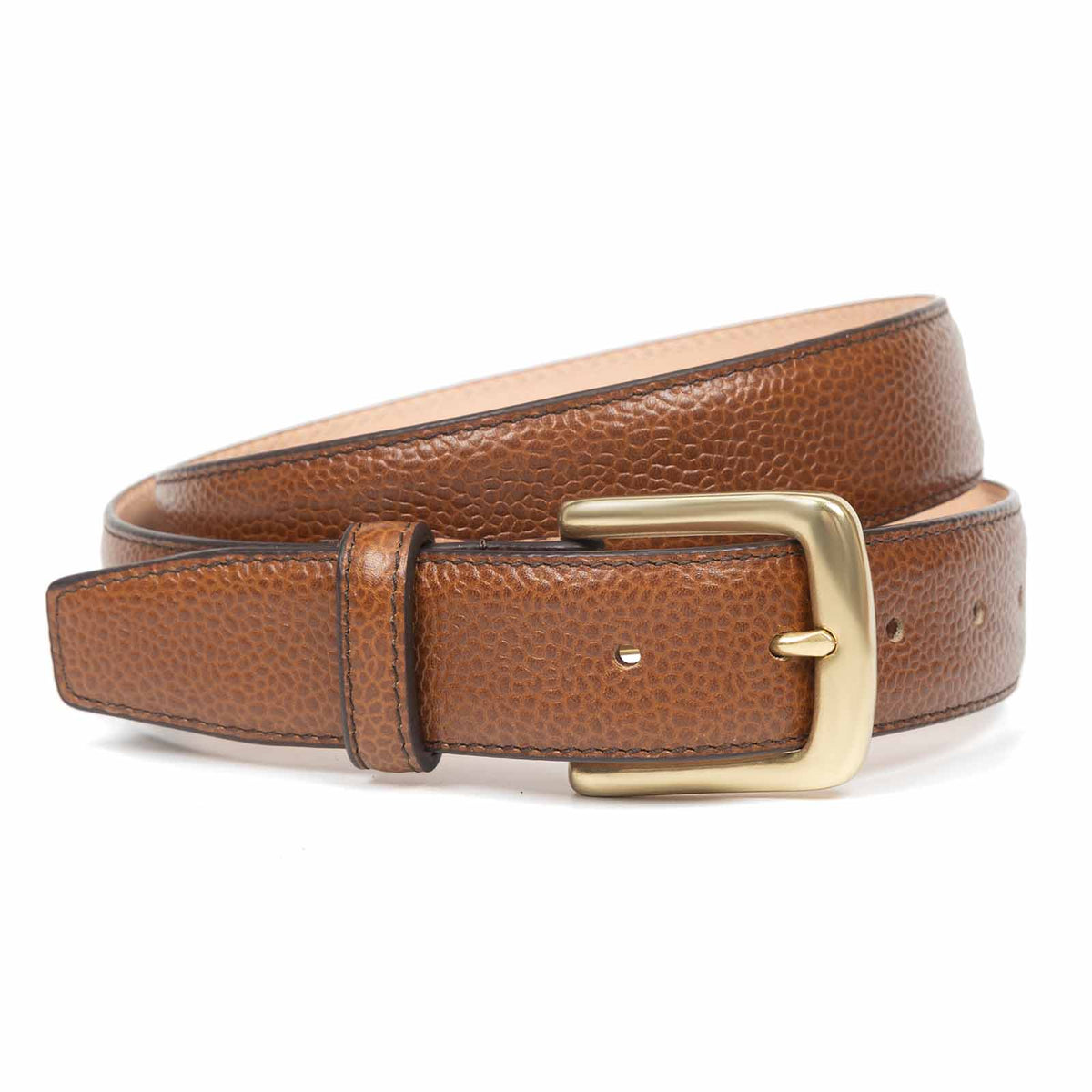Meermin cognac pebble grain leather belt, coiled to show solid brass buckle and full length of strap