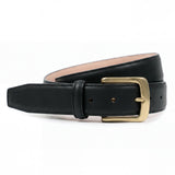 Meermin black waxy calf belt, coiled to show solid brass buckle and leather loop, with pink lining glimpsed on the underside