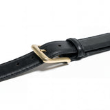 Meermin black waxy calf belt, close-up on solid brass buckle and keeper loop, diagonal angle showing stitched edges