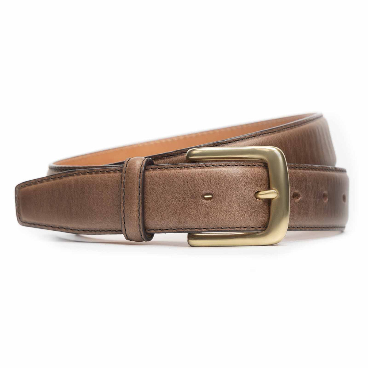 Meermin natural Chromexcel leather belt, coiled to show buckle and strap, with solid brass buckle in focus