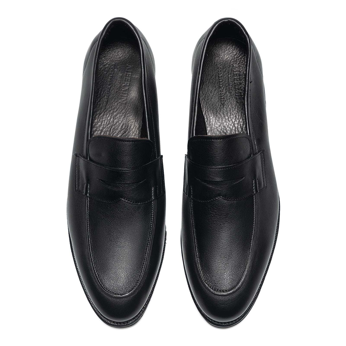 Meermin black softcalf penny loafers, top-down view of both shoes showing the unlined saddle strap and stitching detail