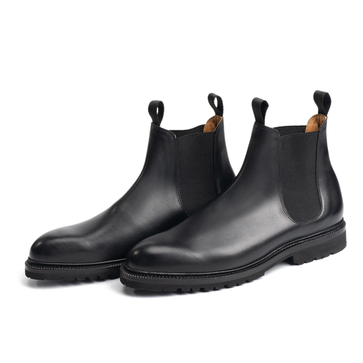 Meermin black boxcalf Chelsea boots, angled front pair view showing elastic side gores and cleated rubber sole