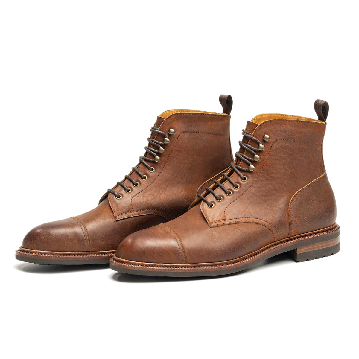 Meermin tobacco waxy shell cordovan cap-toe boots, angled front pair view showing lace-up eyelets and Goodyear welted sole