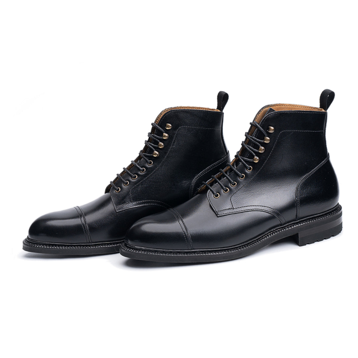 Meermin black boxcalf Jumper boots, front-angled pair view showing cap-toe stitching, lace eyelets, and City Lug rubber sole profile