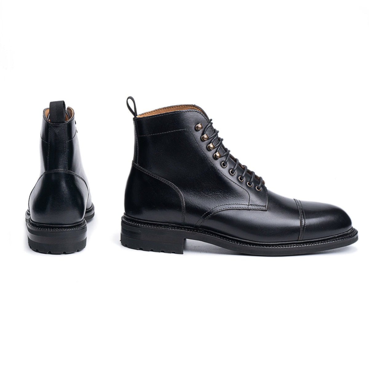 Meermin black boxcalf Jumper boots, side profile and heel view, showing cap-toe stitching, lace-up front, and City Lug rubber sole