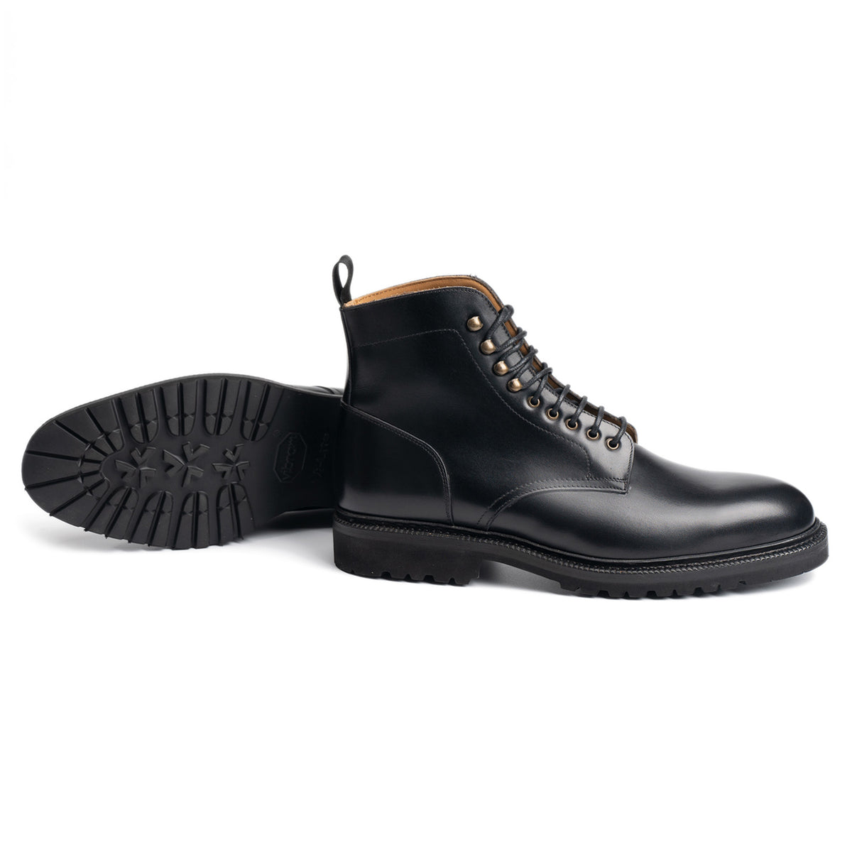 Meermin black calf plain-toe service boot, side profile paired with its sole showing lugged rubber tread and Goodyear welt