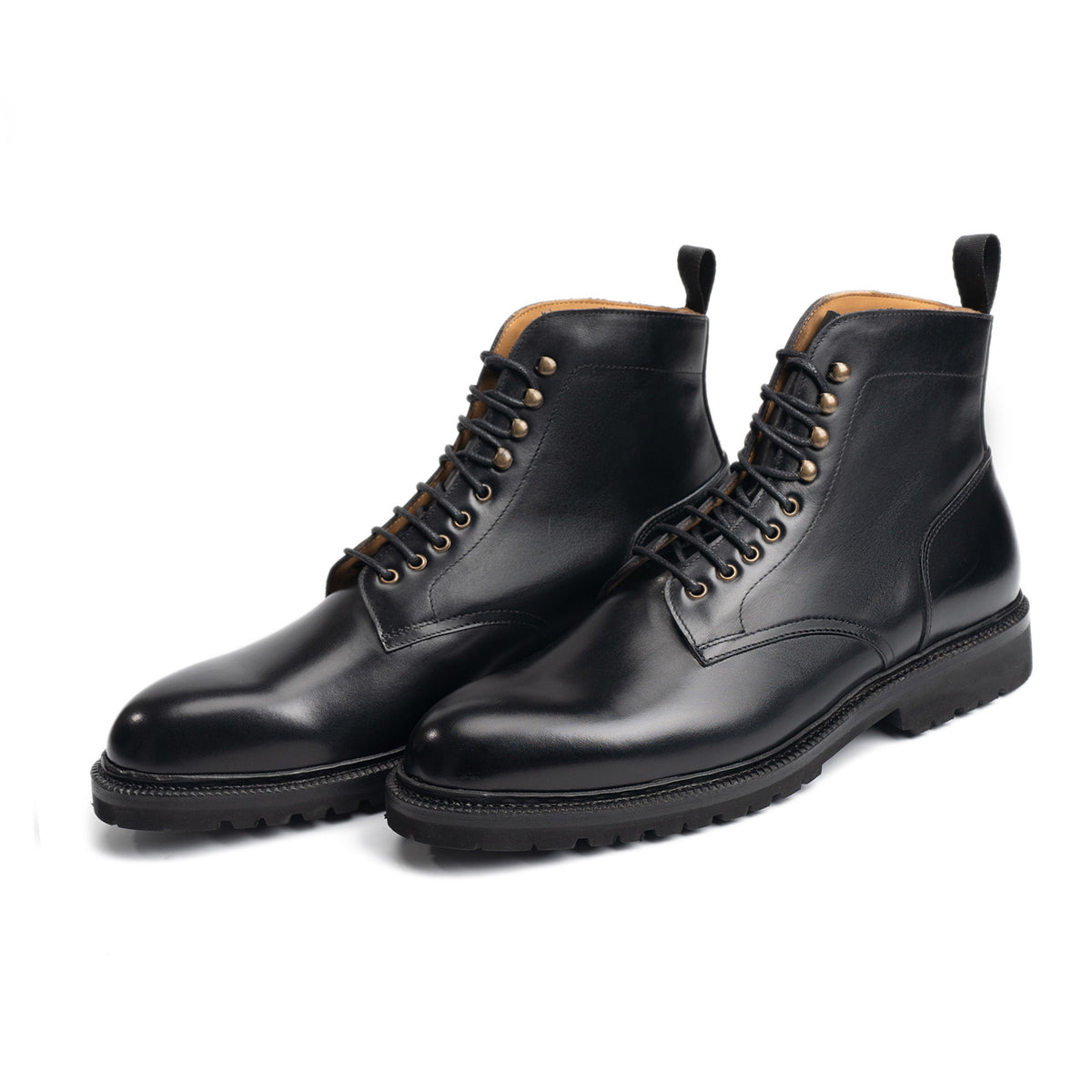 Meermin black calf plain-toe service boots, three-quarter front view showing cleated rubber soles and lace-up detail