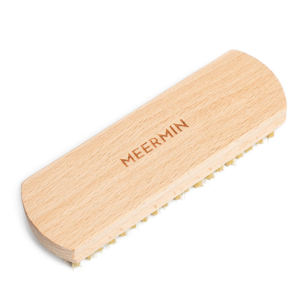 Meermin suede brush, diagonal angled view showing beechwood handle and brass bristle edge along the side