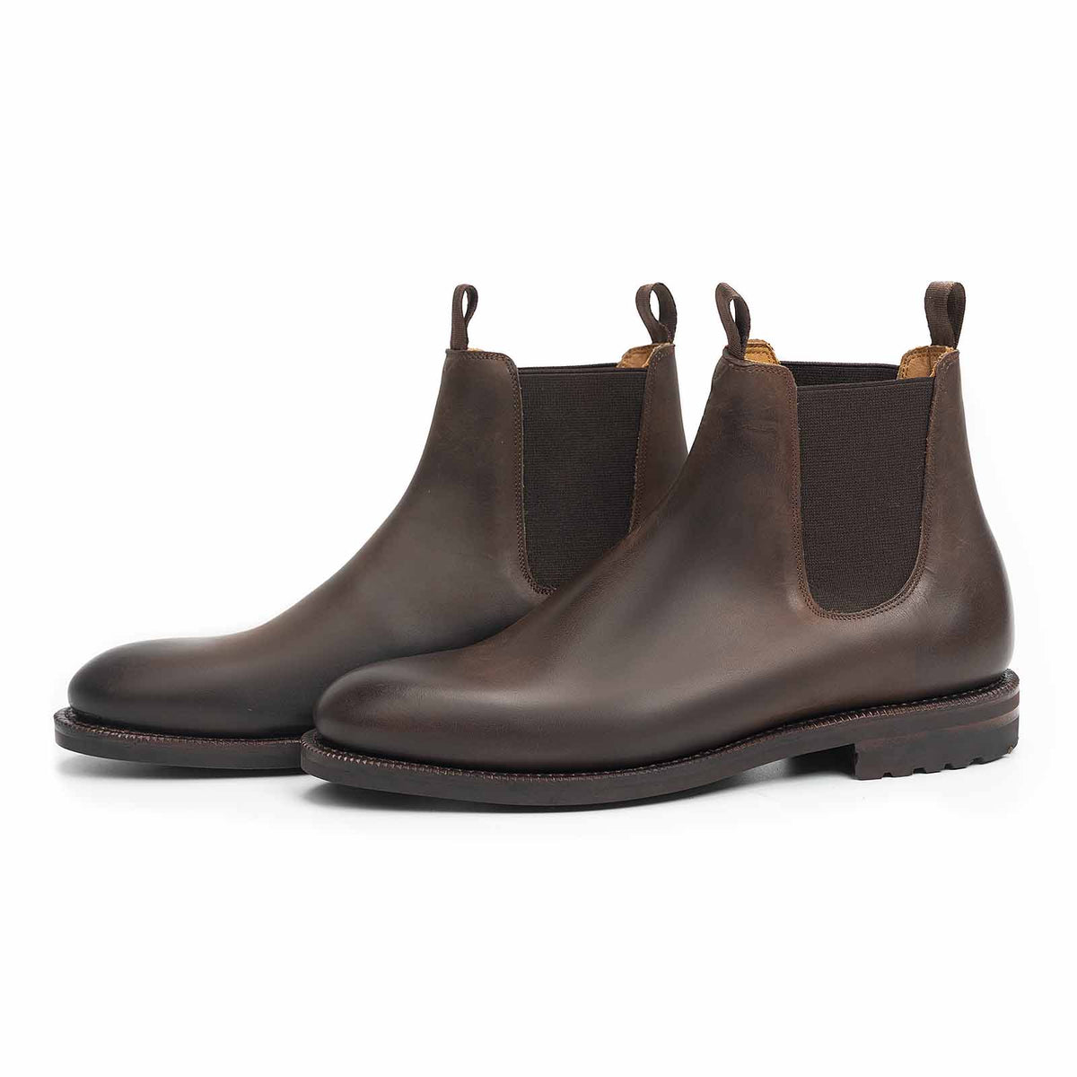 Meermin brown waxy calf Chelsea boots, pair shown at three-quarter angle showcasing elastic gussets and lug outsoles