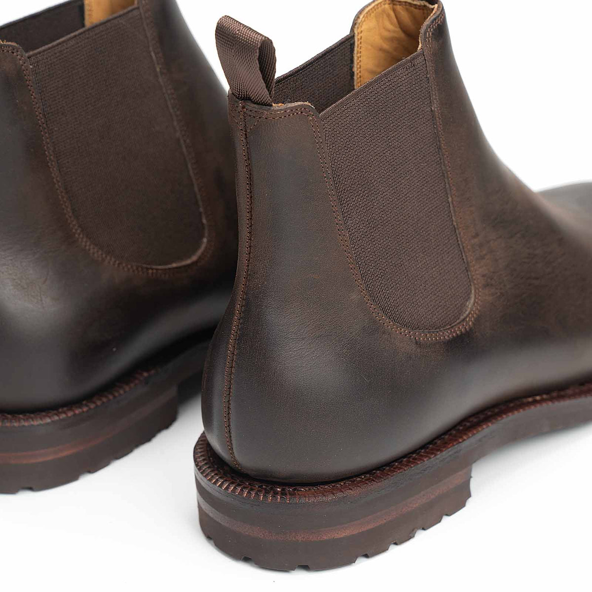 Meermin brown waxy calf Chelsea boots, close-up rear view showing heel pull tab, elastic gussets, and lugged sole