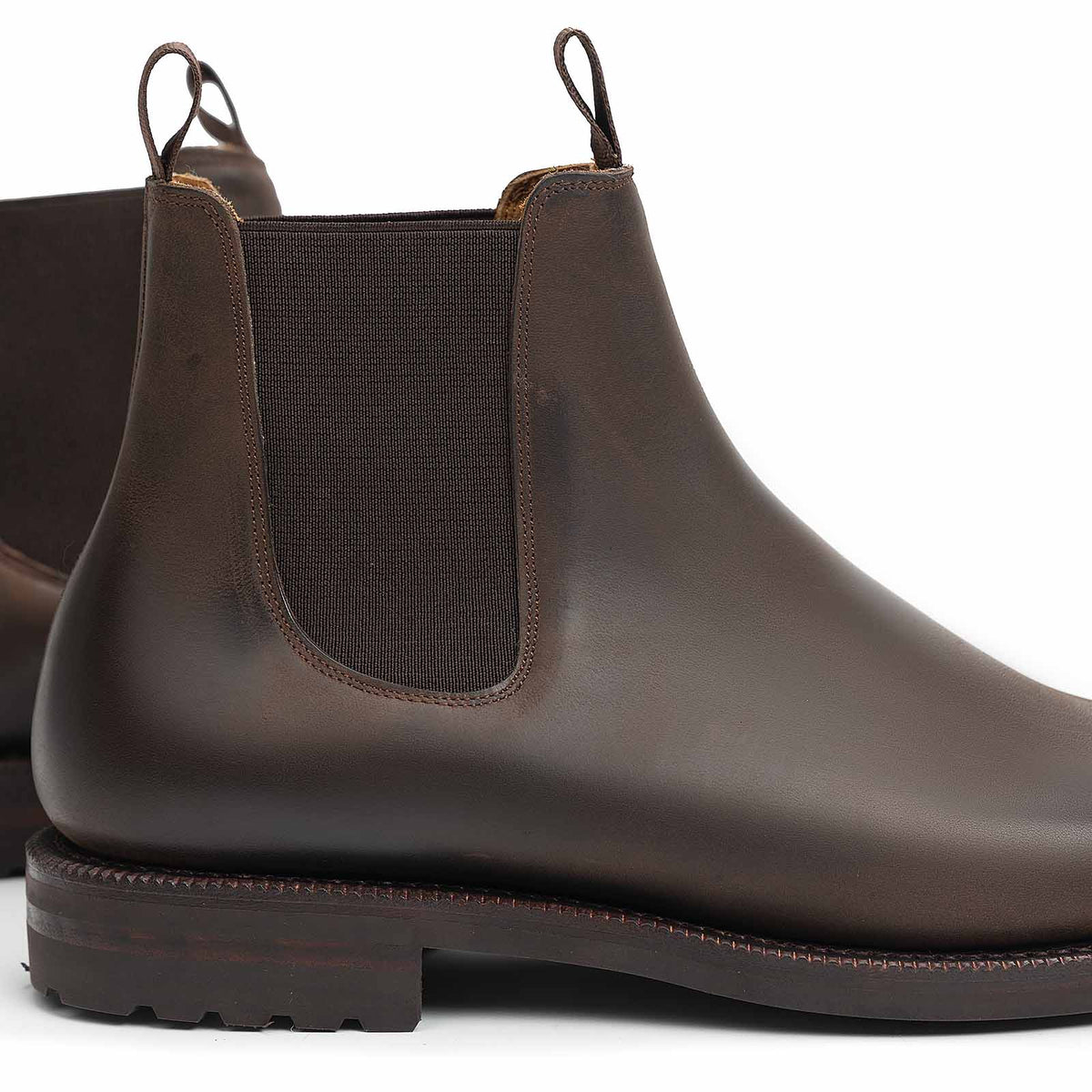 Meermin brown waxy calf Chelsea boot, close-up rear angle showing elastic gusset, pull tab, and lug outsole detail