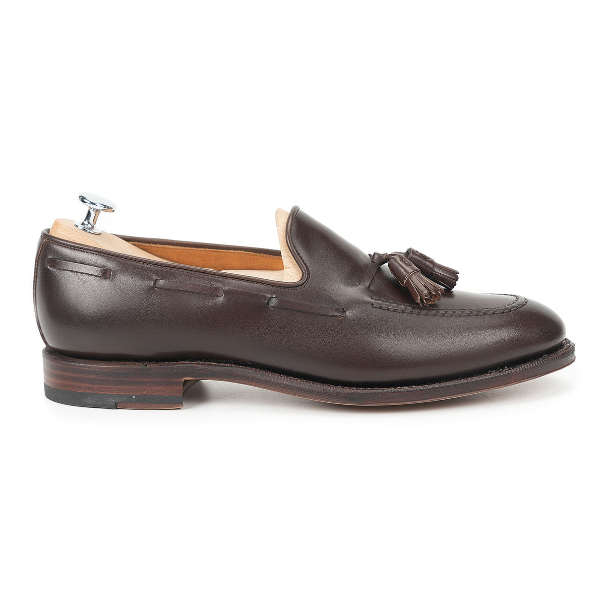 Meermin dark brown boxcalf tassel loafer, side profile on a shoe tree, showing hand-sewn apron and Goodyear welted sole