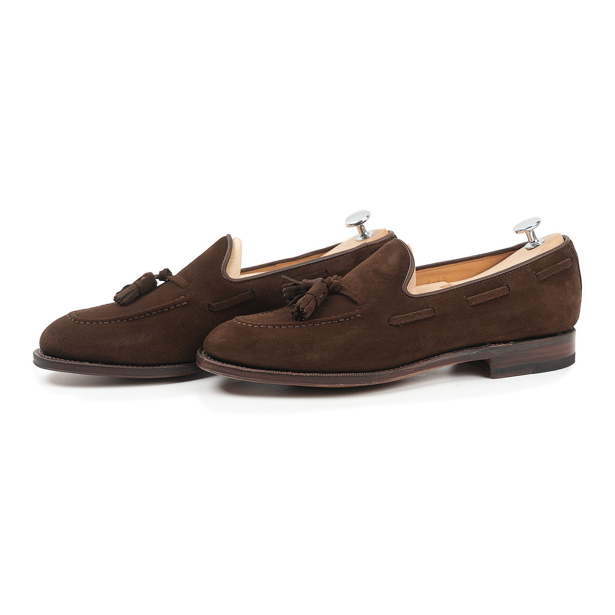 Meermin brown suede tassel loafers, side-by-side pair on shoe trees, showing hand-sewn apron and tassel detail