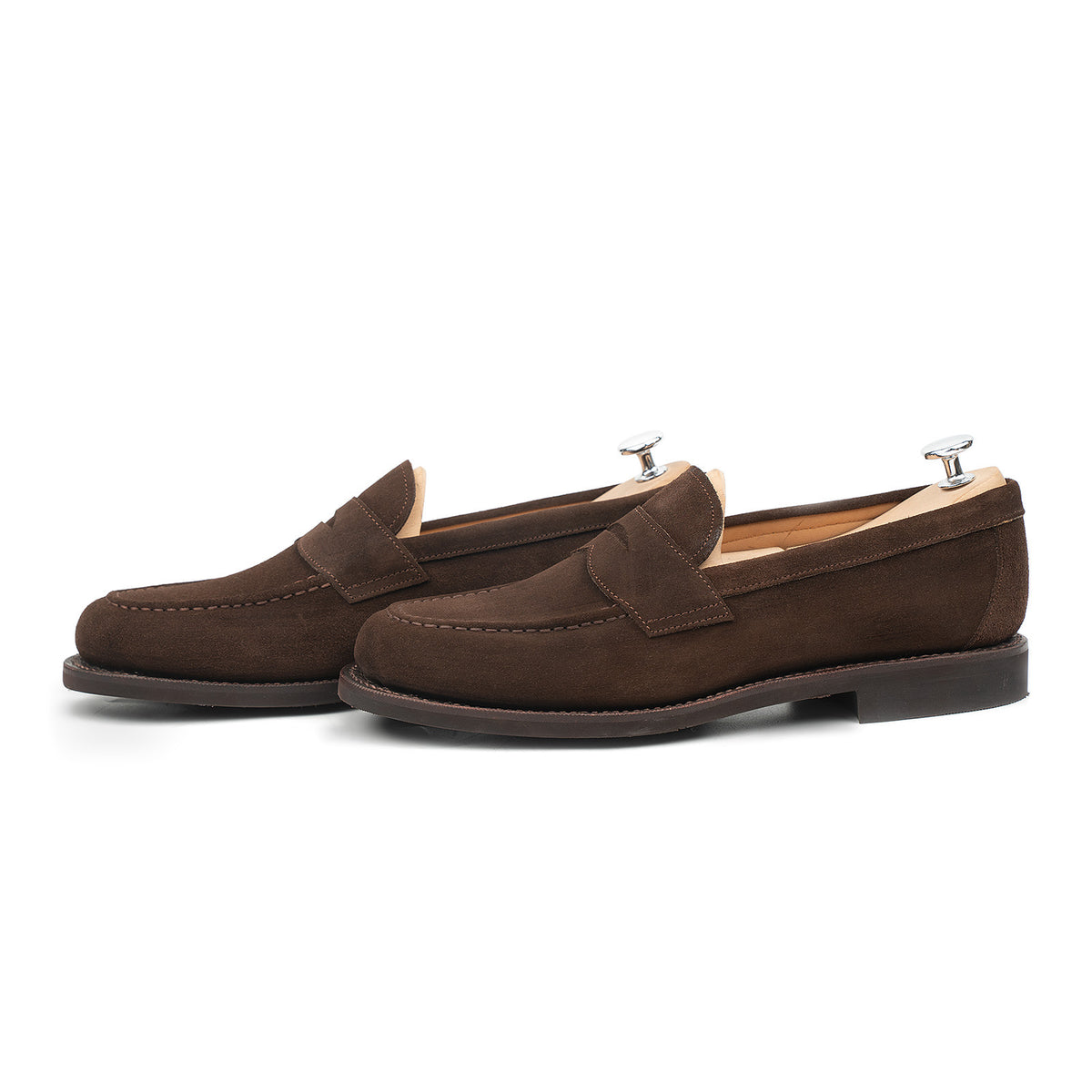 Meermin brown suede penny loafers, side profile pair on shoe trees, showing apron stitching and flex Goodyear welt sole