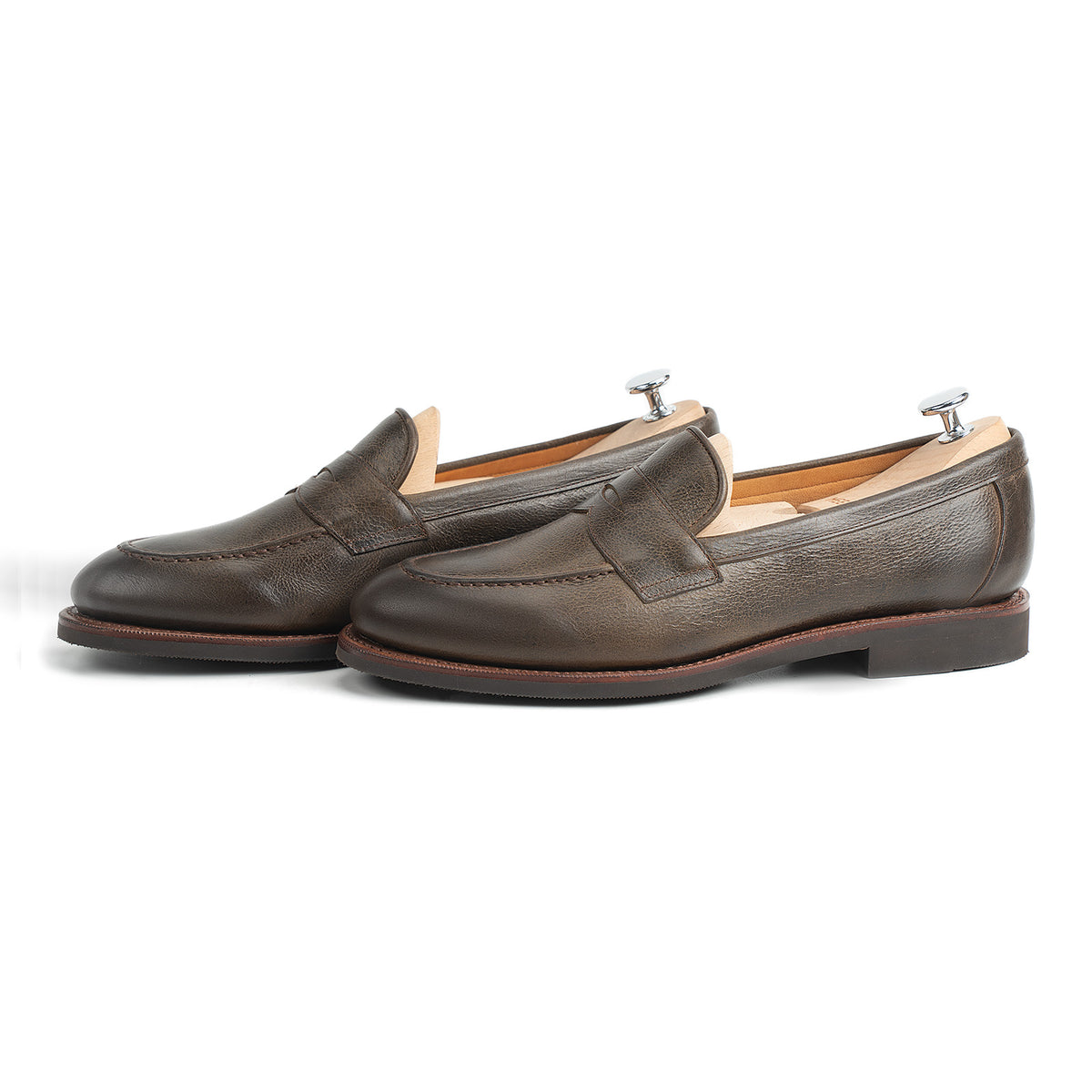 Meermin Caper Green Naked Kudu penny loafers, side-by-side profile view with shoe trees inserted, showing grain texture and welt