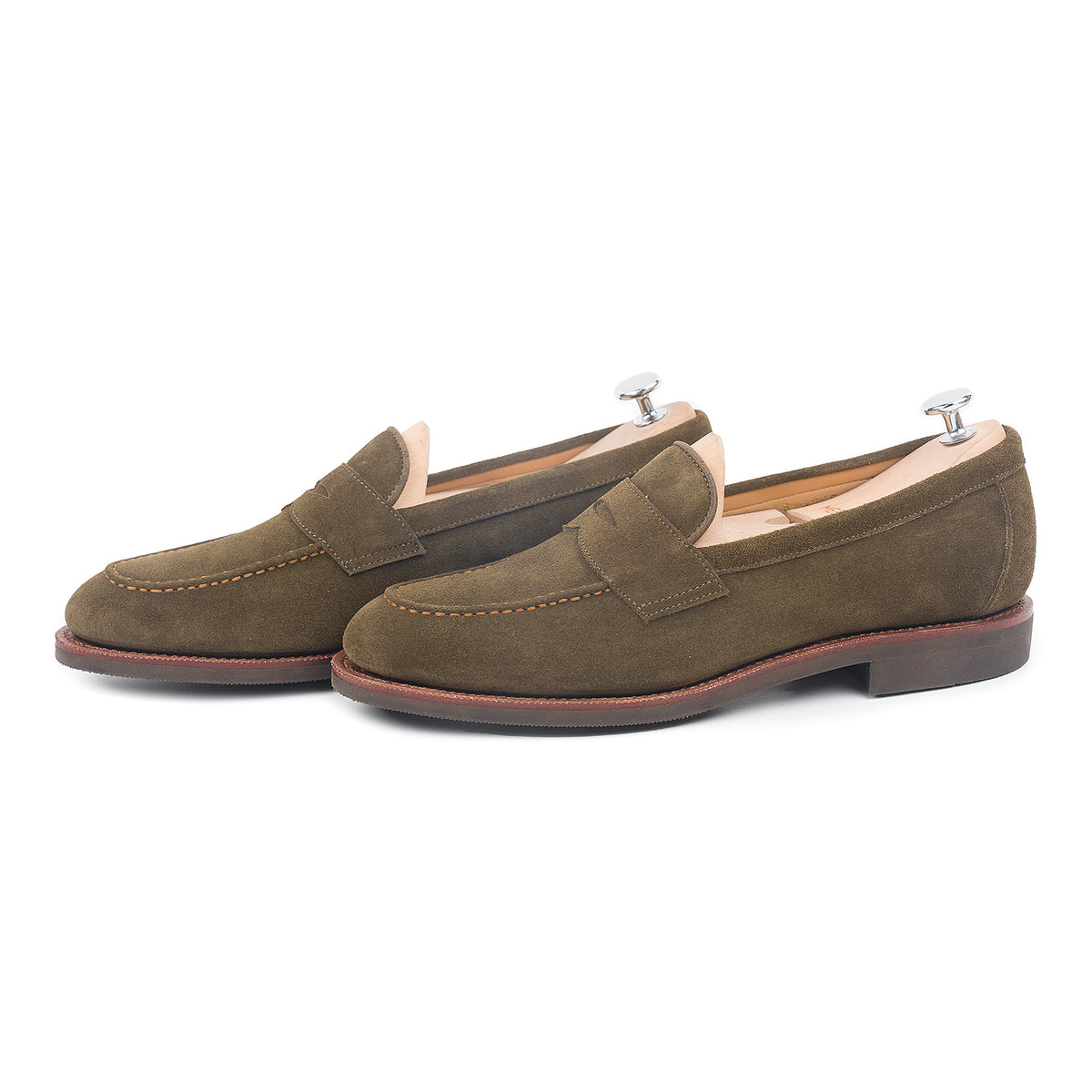 Meermin hunting green suede penny loafers, side-by-side pair on shoe trees, showing suede texture and stitched apron detail