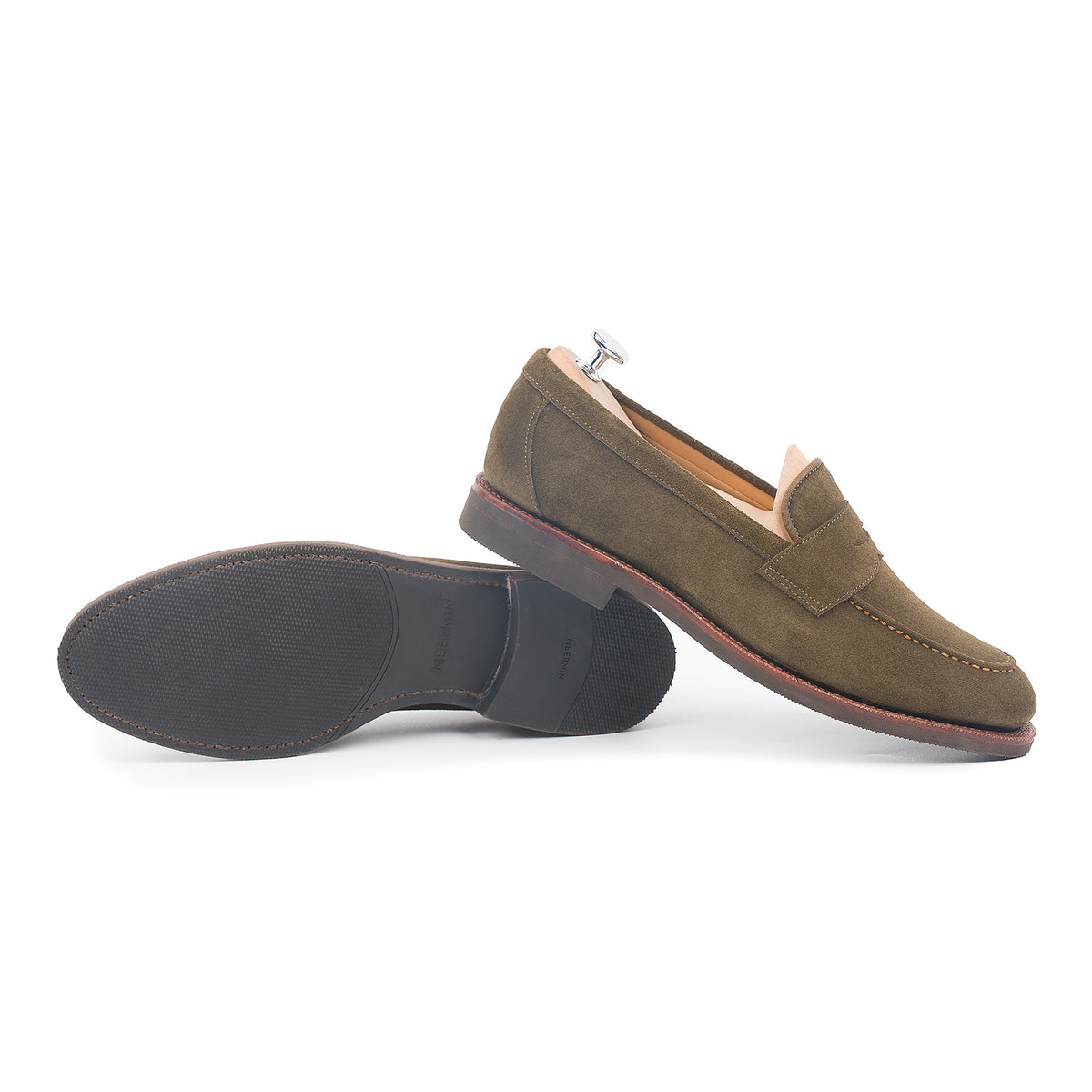 Meermin hunting green suede penny loafers, one upright on shoe tree, other tipped to show diamond rubber sole