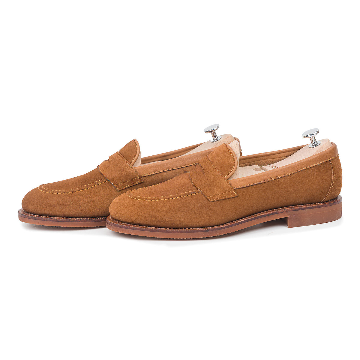 Meermin copper Alicante suede penny loafers, three-quarter side view on shoe trees, showing apron stitching and diamond latex rubber sole