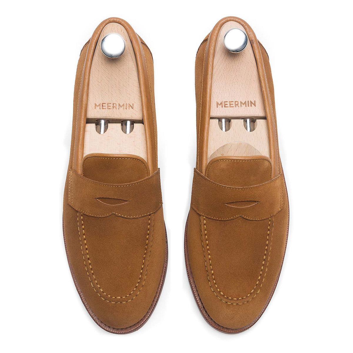 Meermin copper Alicante suede penny loafers, top-down view on shoe trees, showing apron stitching and saddle detail