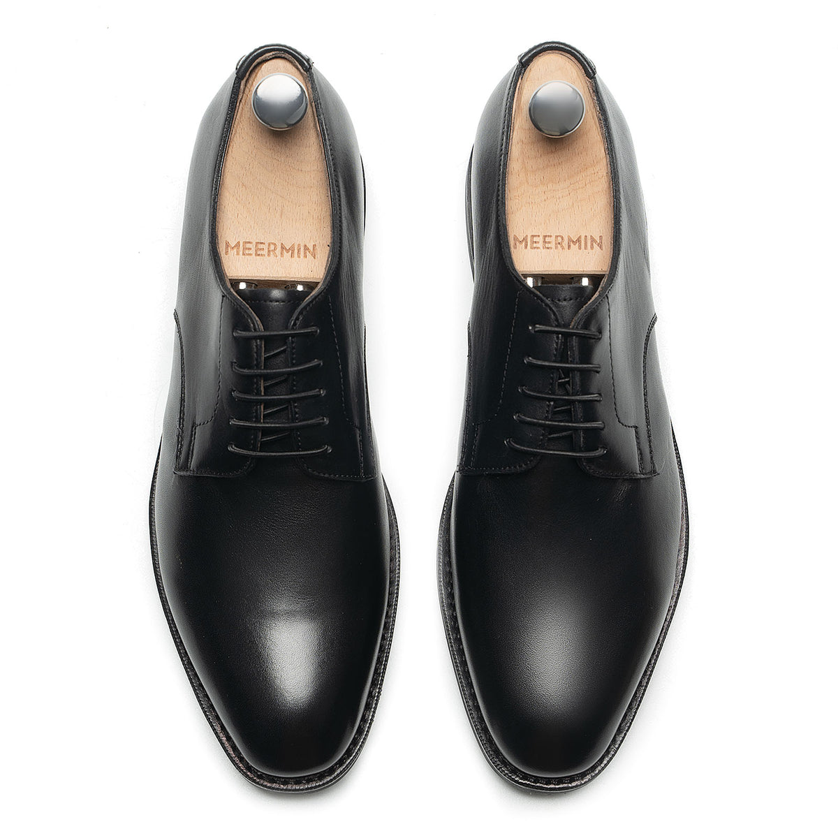 Meermin black silkcalf plain-toe bluchers, overhead view of both shoes with shoe trees, showing lacing and toe shape